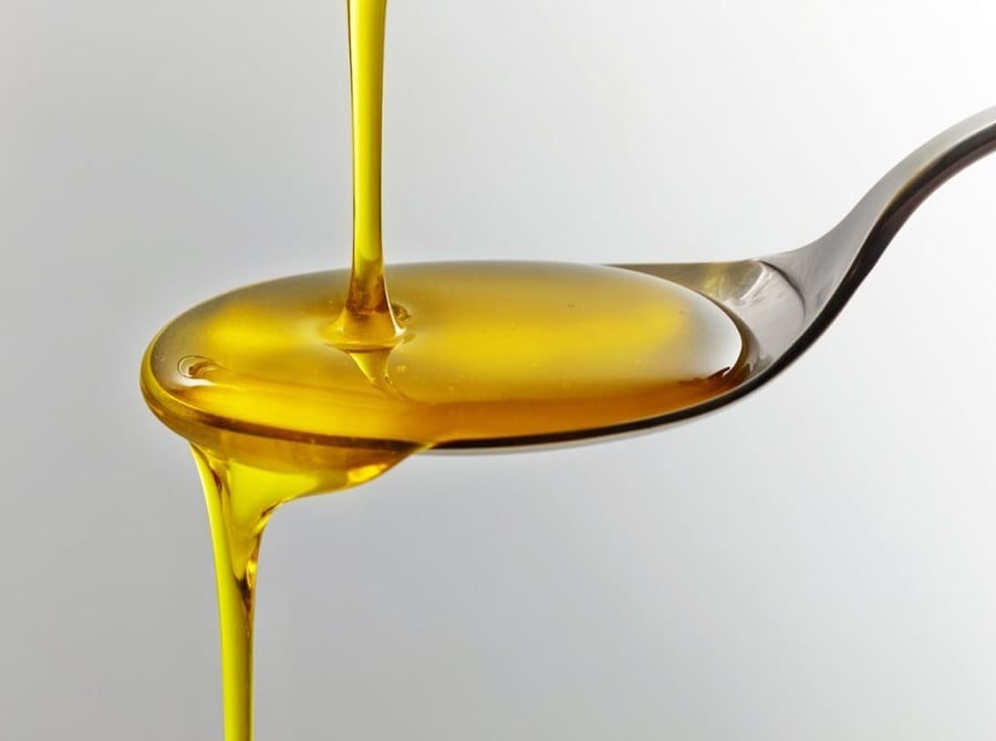 fish oil poured onto spoon